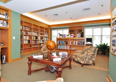 Large library with sitting area and coffee table.