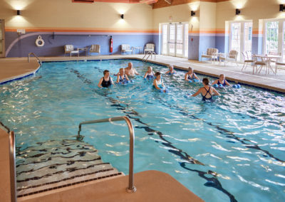 People participating in an indoor water aerobics class.