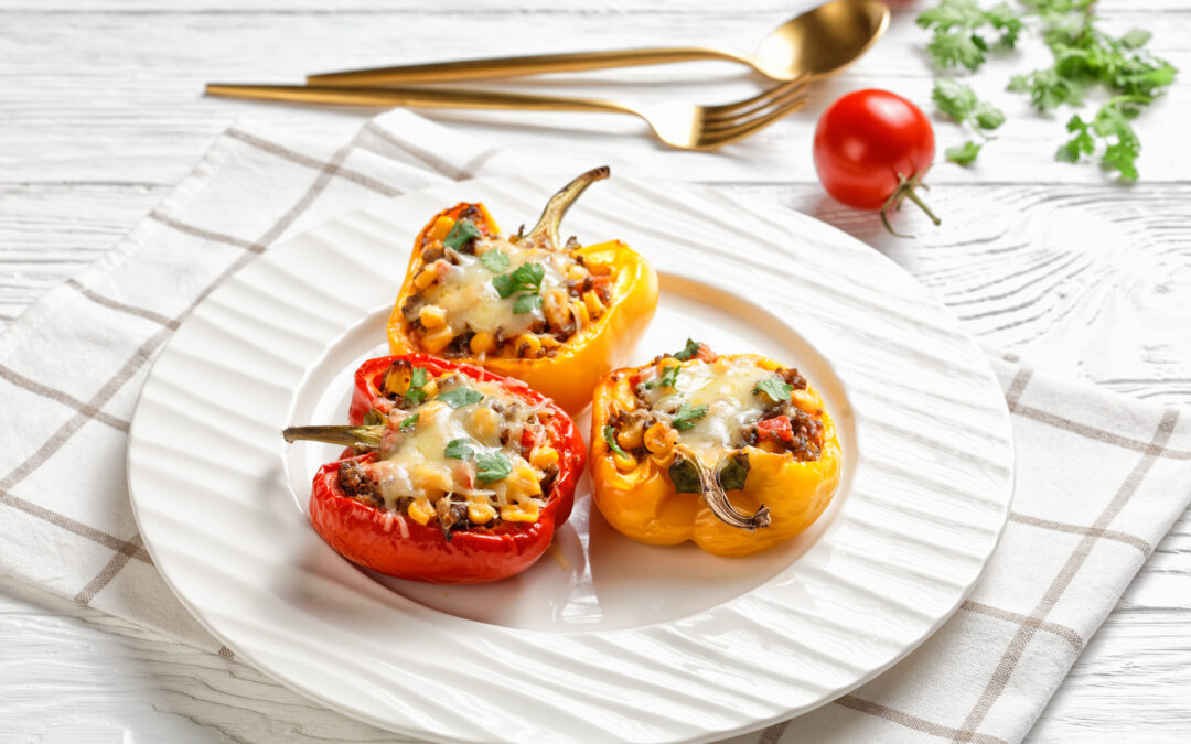 stuffed bell peppers with ground beef, corn and cheese on a plate