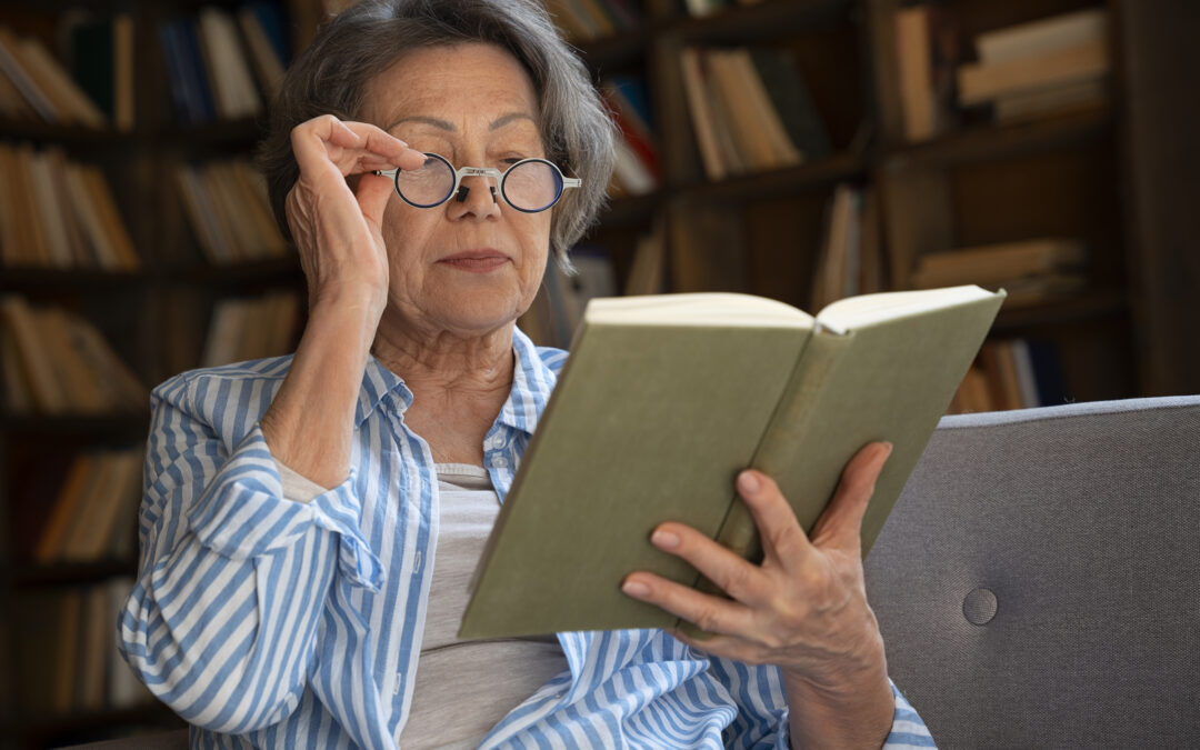 senior woman reads a book in the library