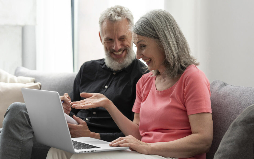 Senior couple working together at a laptop.